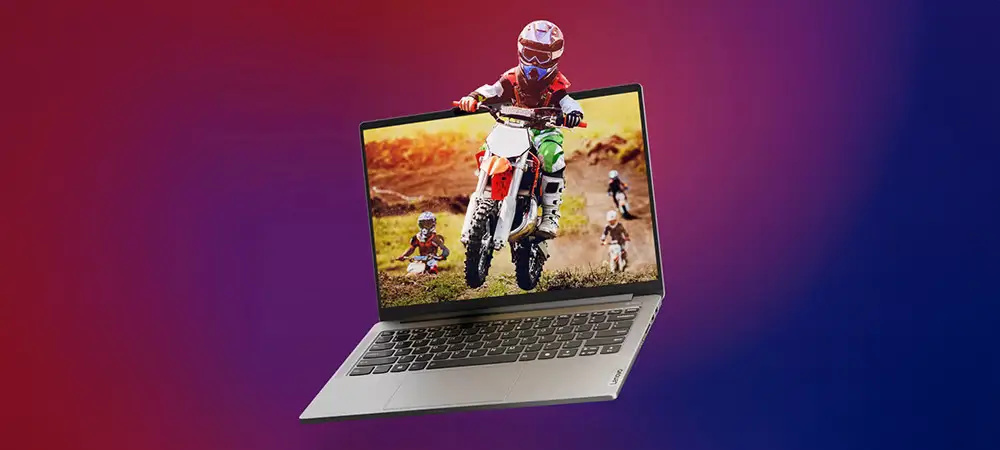 Lenovo IdeaPad Pro 5i על רקע שיפוע אדום וכחול מציג תמונה של ילד רוכב על אופני מוטוקרוס, כשהגלגל הקדמי נראה קופץ מהמסך, יוצר אפקט תלת מימד, המציג יעילות בינה מלאכותית במחשב הנייד הזה המופעל על ידי אינטל.